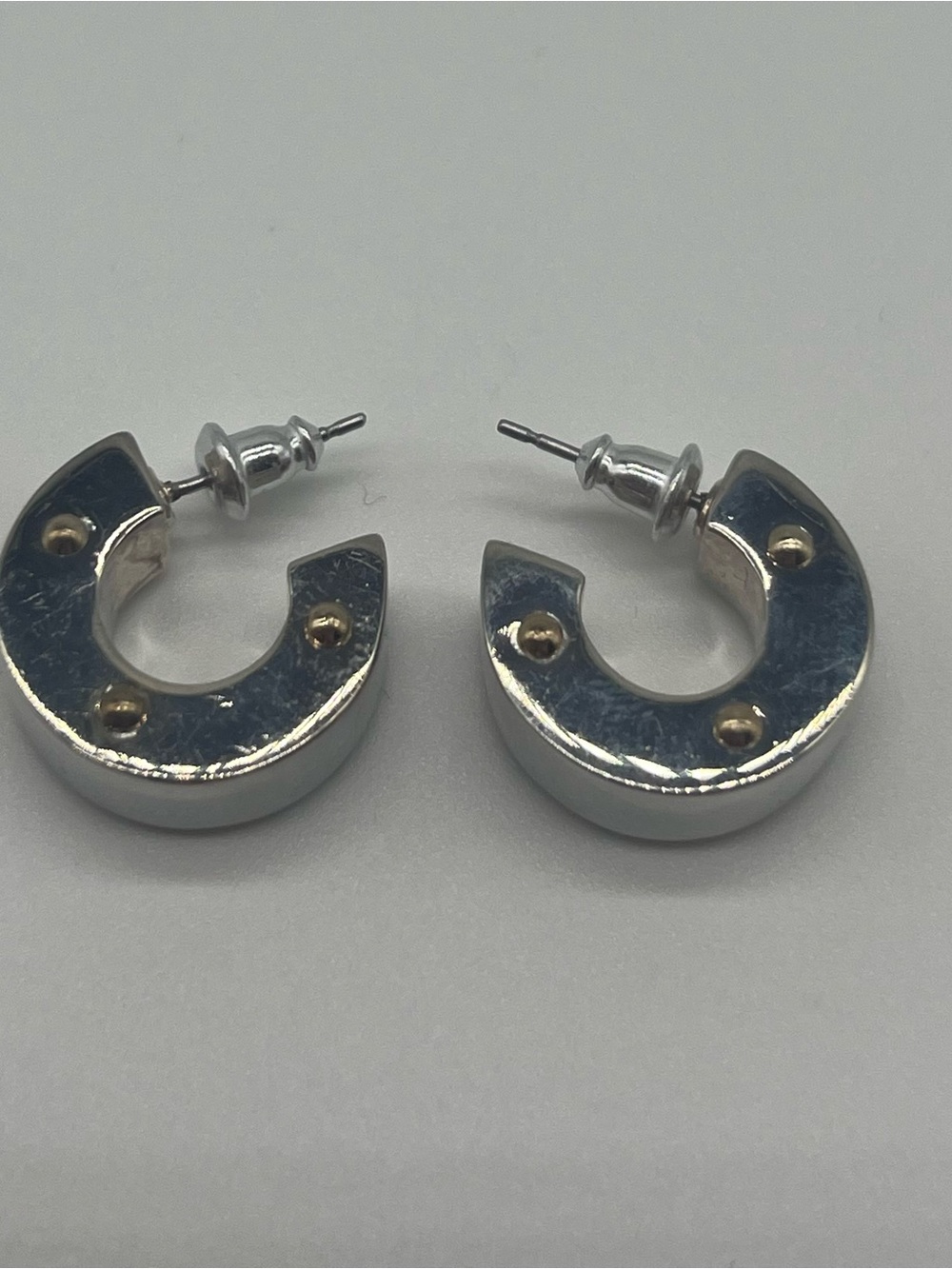 Monet Two-Tone Silver C-Shape Hoop Earrings with Gold Accents